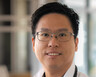 Chenyu Lin smiles outside. The text beside him reads "Conversations in Cancer: Cell Therapy"