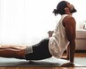 A man holds a upward facing dog yoga pose to stretch his back