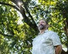 Bob Blake stands under a large tree