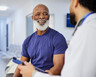 A doctor sits and talks with a patient