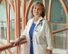 Susan Dent, MD, a cardio-oncologist smiles inside the Duke Cancer Center 