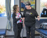 Physical therapist Katie Hester helps support a patient during a standing exercise.