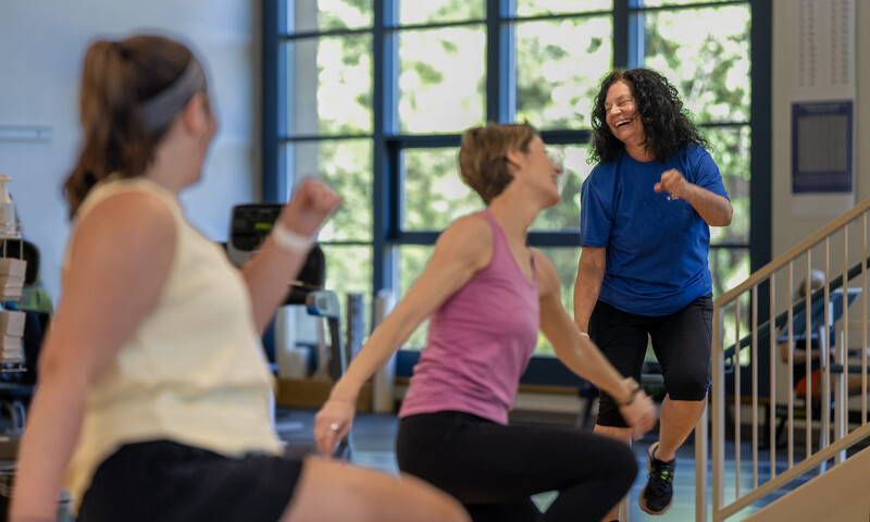 An instructor leads a group fitness class