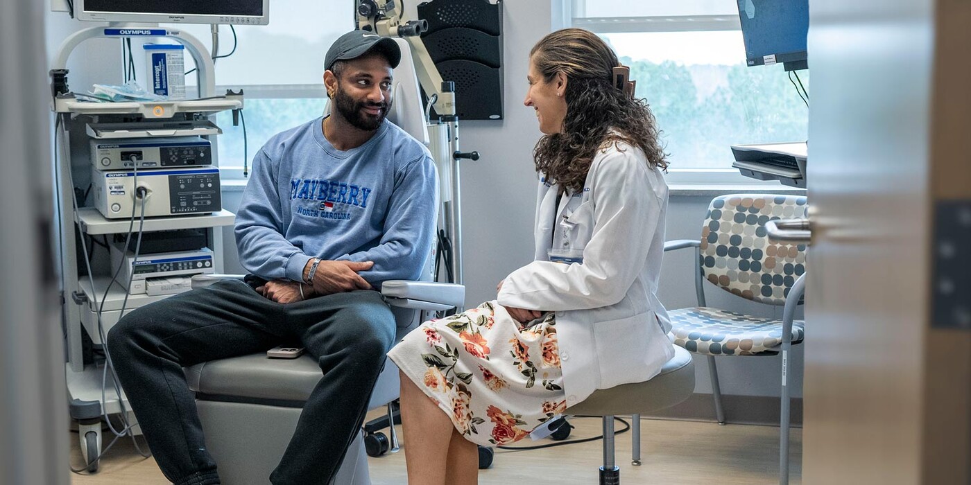 A doctor and patient talk in a clinic room