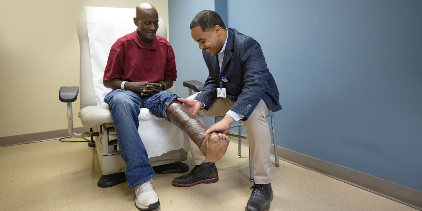 Doctor examining patient's leg