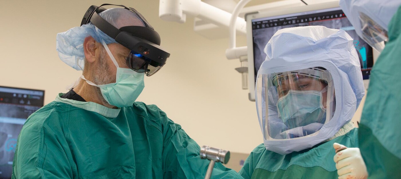 A surgeon uses an augmented reality system while operating