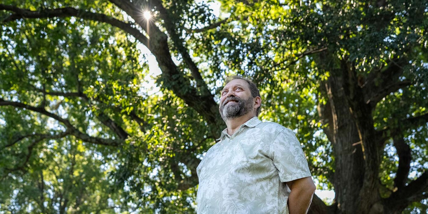 Bob Blake stands under a large tree