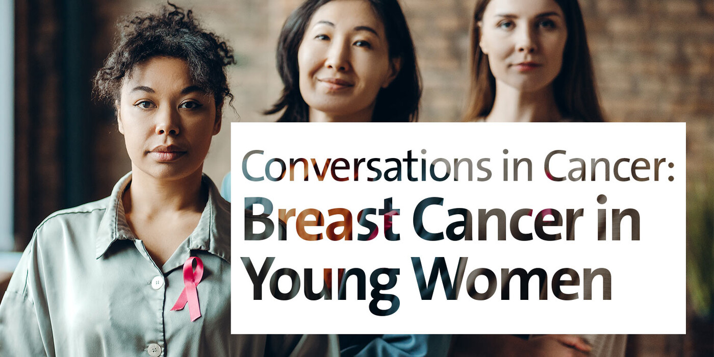 Three women with breast cancer ribbons look at the camera