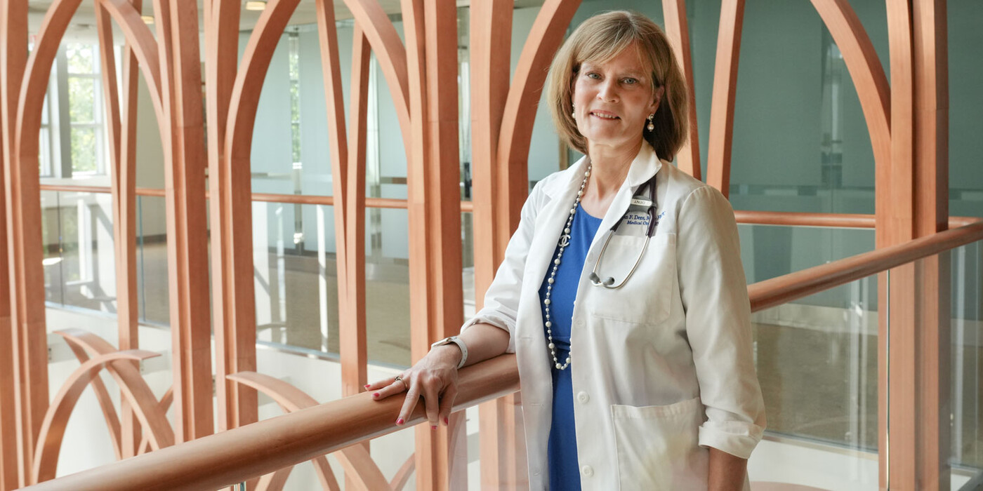 Susan Dent, MD, a cardio-oncologist smiles inside the Duke Cancer Center 