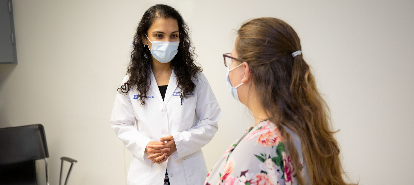 Epileptologist Prachi Parikh, MD speaks with a patient in clinic.
