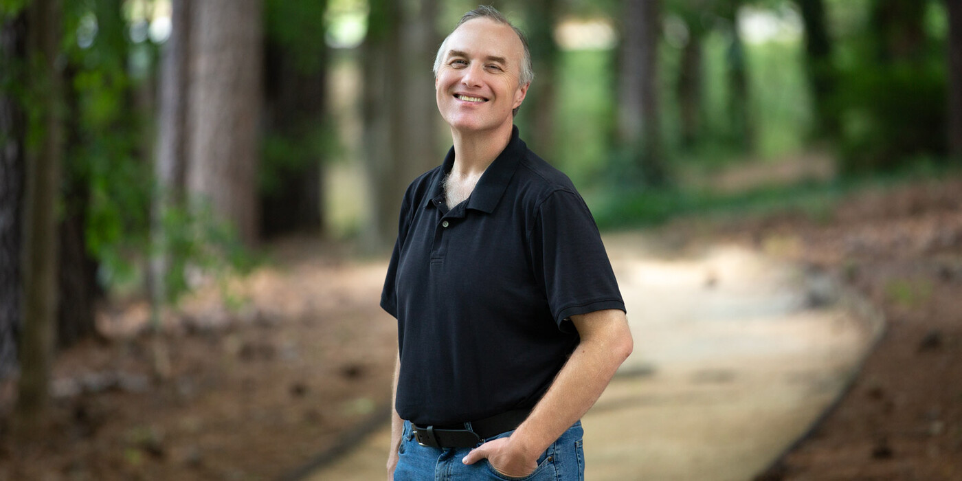 Jeff Stewart smiles on a walking path near his home in Cary, NC.