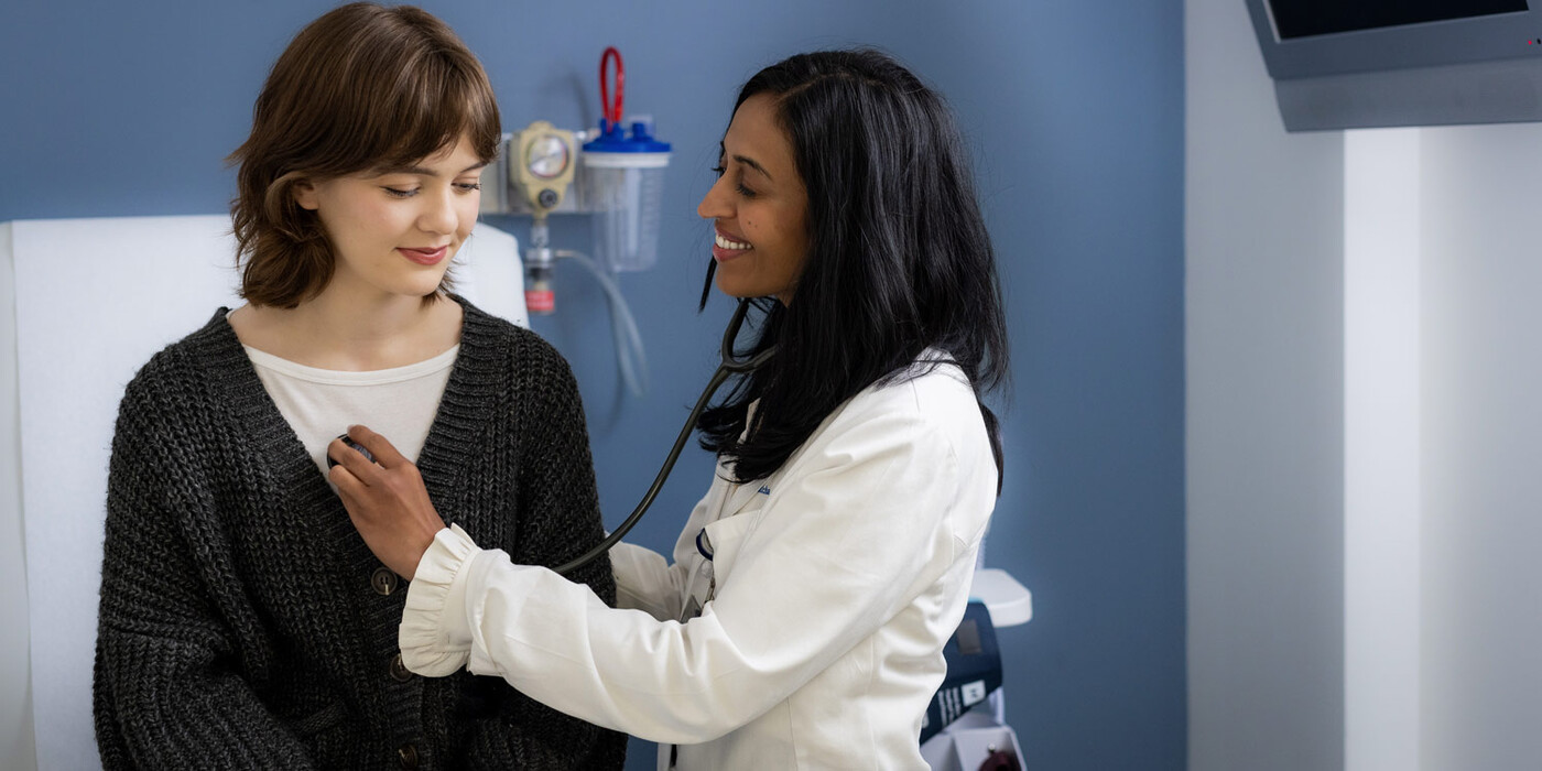 A doctor listens to a patient's heart