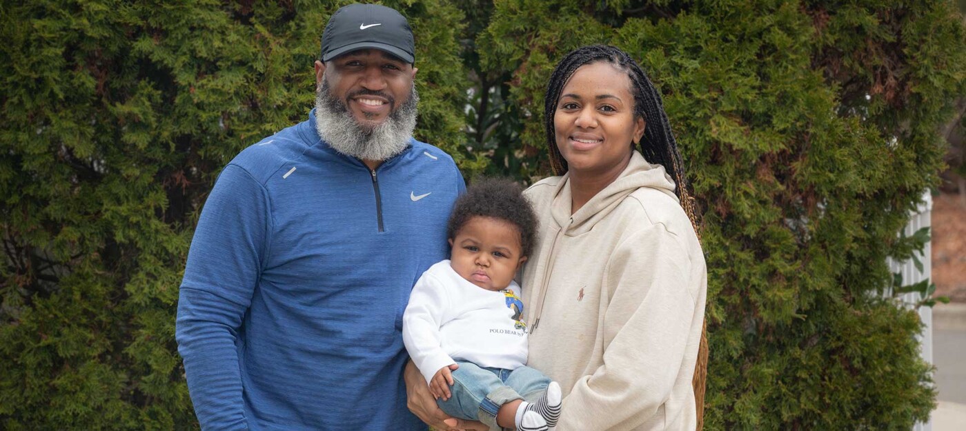 Tyrone and Tisha Hibbler hold their son, King, outside in Durham.