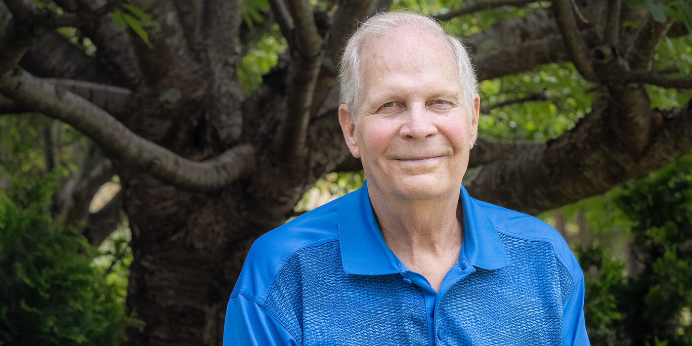 Ned Steele stands in front of a tree