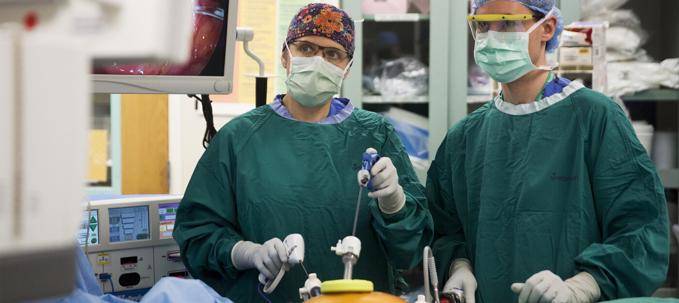 Julie Thacker, MD, left, and surgical resident Paul Speicher perform surgery at Duke University Hospital.