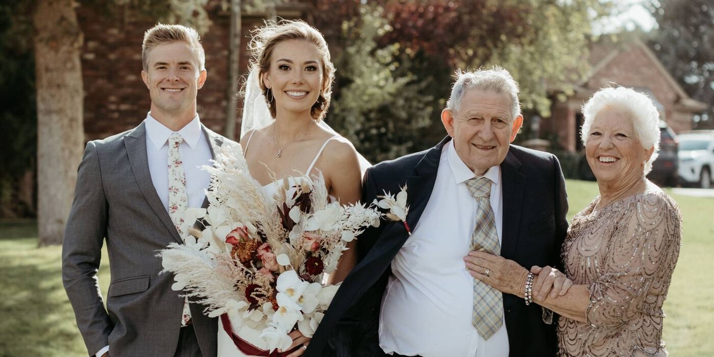 Wedding photo shows bride, groom and grandparents