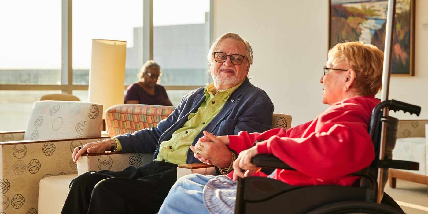 couple look at each other in cancer waiting room