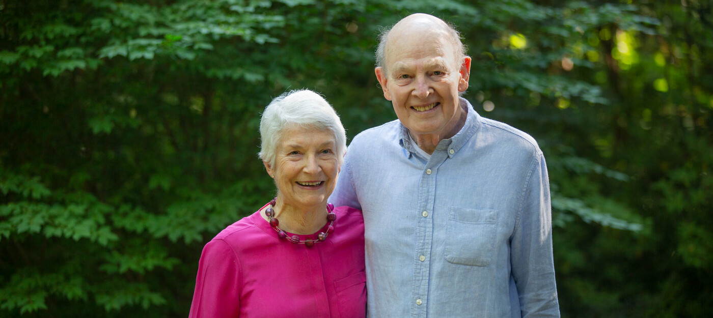 Margaret and Richard Hodel stand in the backyard of their home in Durham, NC.