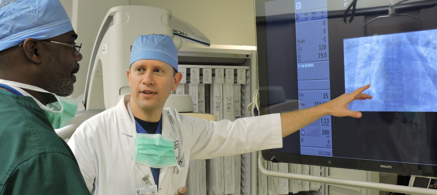 Dr. Matthew Brennan and cardiovascular invasive specialist Raheen Jordan review an X-ray in Duke Regional Hospital’s new cardiac cath lab