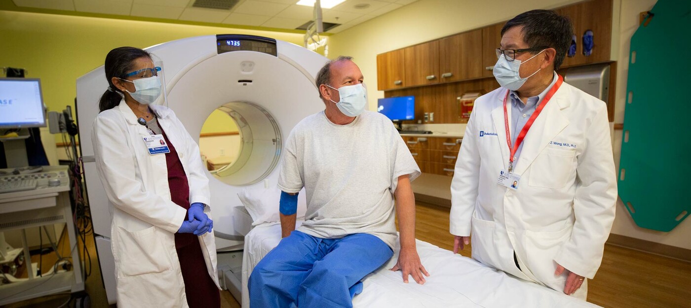 Two providers meet with a patient before their (PSMA) PET/CT