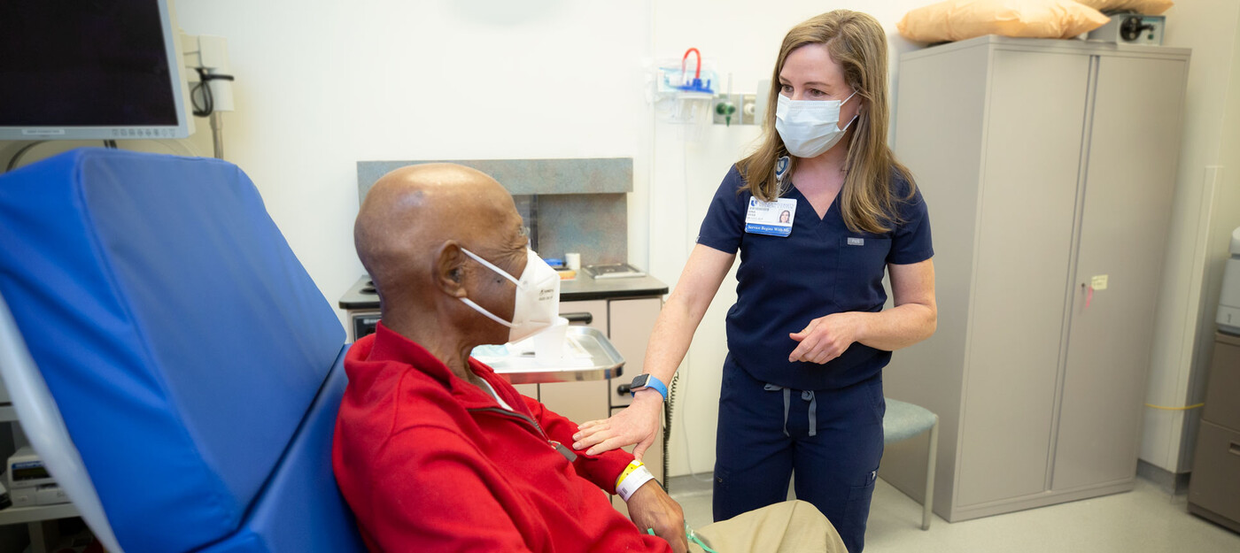 A provider talks with a patient before a procedure.