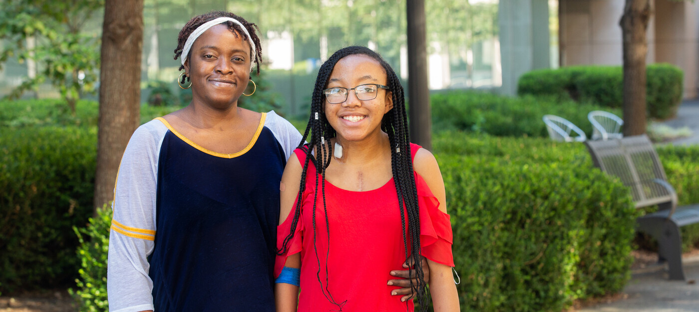 Teyanna Ingram and daughter Tyra pose together outside of Duke University Hospital.