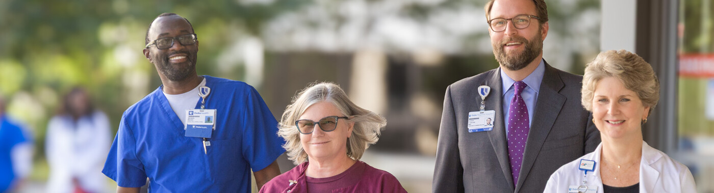 Four team members walk together outside 