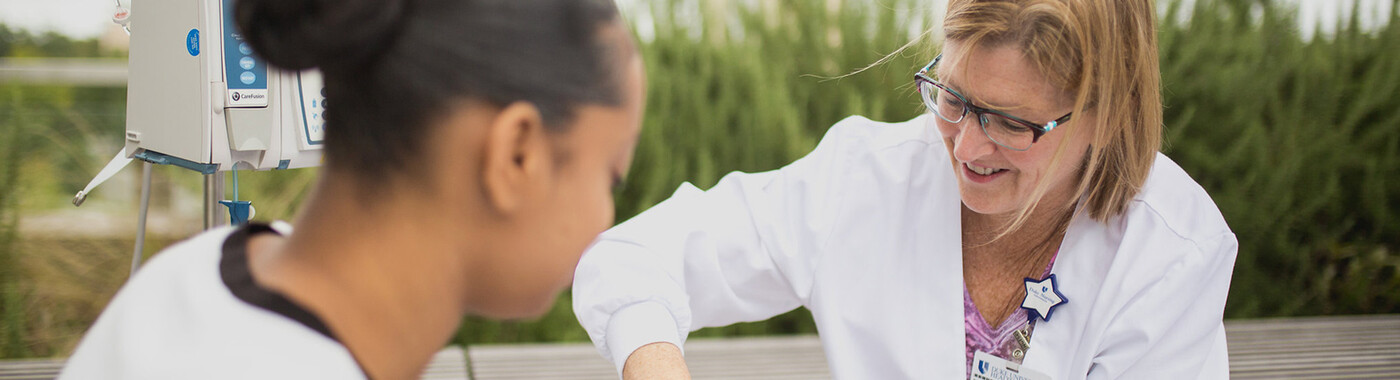 A doctor administers medication to a patient on an outdoor patio
