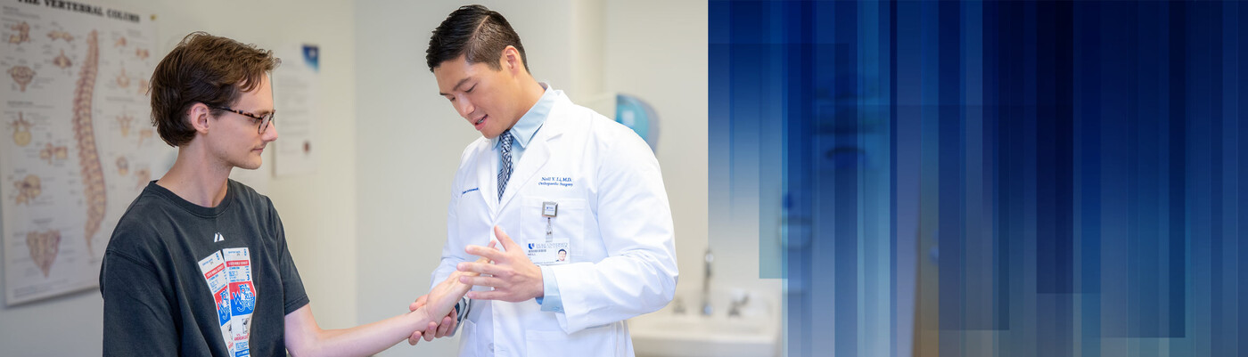 A doctor examines a patient's hand