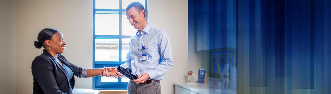 Provider giving a patient a brace for her wrist