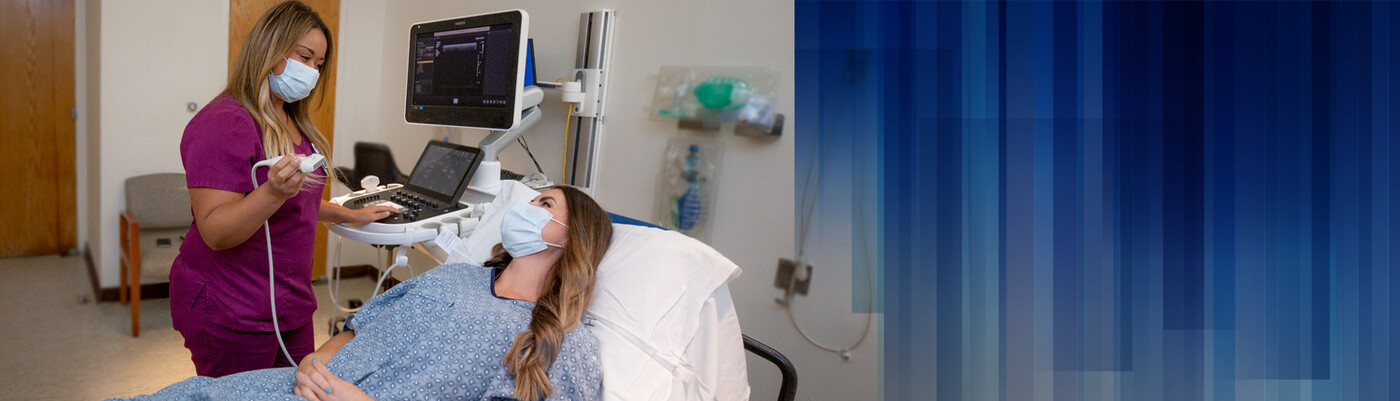 A provider speaks with a patient before beginning an ultrasound
