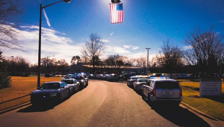 a flag flies above at Zach's funeral