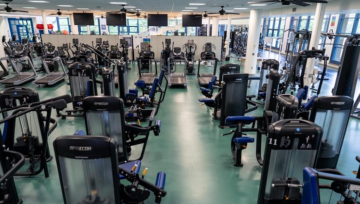 The interior of the gym with cardio and weight equipment