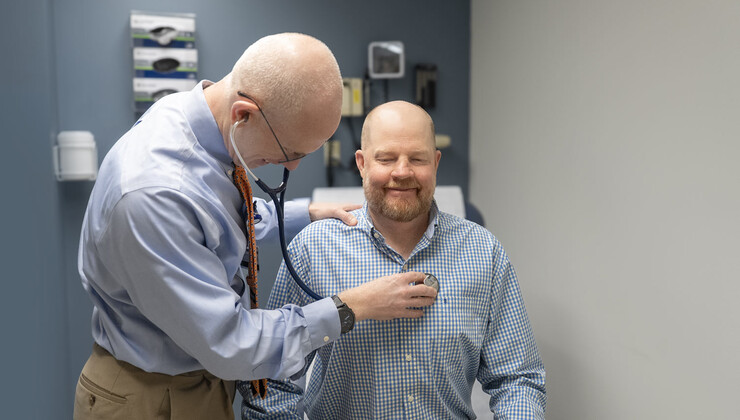 Kidney transplant specialist Scott Sanoff, MD, listens to Dustin Smith's heart.