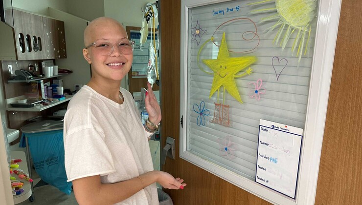 Isabella shows off her decorated hospital room door.