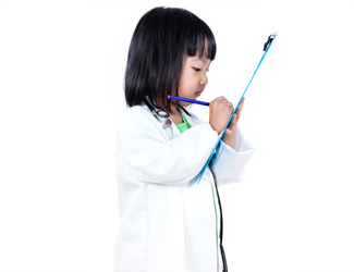 A child looks at a clipboard 