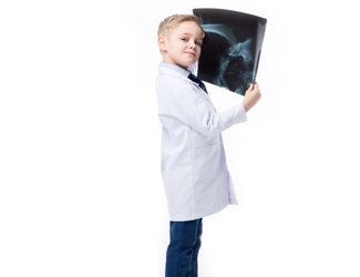 A child holds up an x-ray